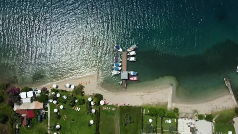 Aerial top down view of beach shore with private properties with beach front Stock Footage 245604871