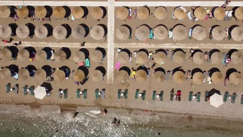 Aerial top down view of beach in Greece umbrellas  sea shore people relaxing Stock Footage 246122958