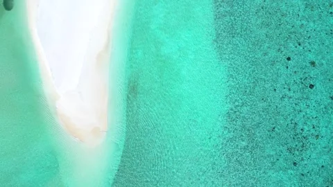 Aerial top down view of a beach surrounded by turquoise ocean Stock Footage 263917247