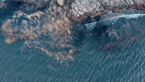 Aerial top-down view of beautiful sea coast. Epic drone shot observing ocean Stock Footage 125337597