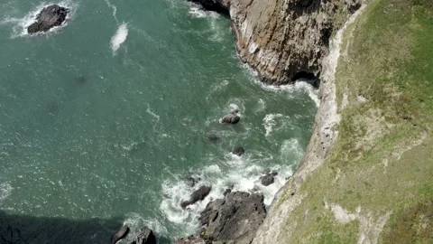 Aerial top down view of beautiful cliffs being washed out by water in the sea. Stock Footage 164130022