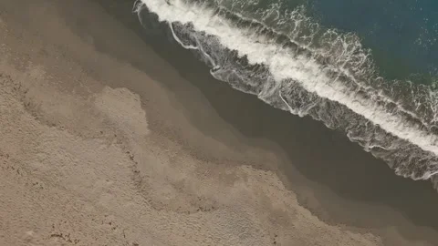 Aerial top down view of beautiful turquoise sea waves breaking on sand beach Stock Footage 257691324