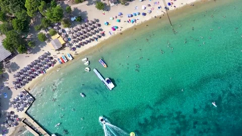 Aerial top down view of a beautiful beach with water sports Stock Footage 294535315