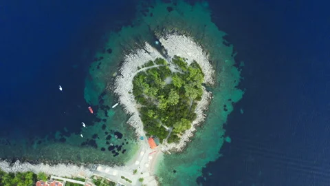 Aerial top down view of a beautiful small island in the turquoise Adriatic Sea Stock Footage 318478580