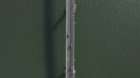 Aerial top down view of bikers going on bridge over river. Road above water. Stock Footage 128215752
