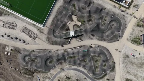 Aerial top down view of a bmx pump track circuit Stock Footage 337778608