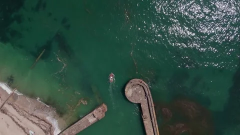 Aerial Top Down View of Boat Leaving Charlestown Harbour in Cornwall England Stock Footage 337508901