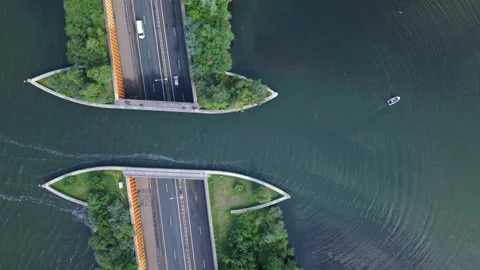 Aerial top down view of boat passing over the Aqueduct Veluwemeer Stock Footage 338015261