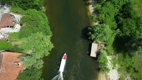 Aerial top-down view of a boat on Rijeka Crnojevica, Montenegro Stock Footage 338027680