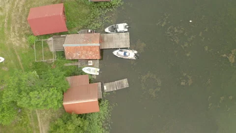 Aerial top down view of boathouses along shoreline in the archipelago Stock Footage 134917976