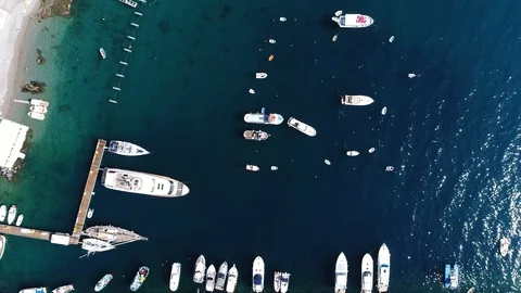 Aerial top down view of boats docked at bay near coastline 4k Stock Footage 111068053