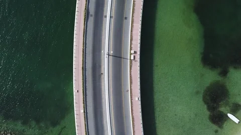 Aerial top down view of a bridge above water with one white car passing. Stock Footage 135406100