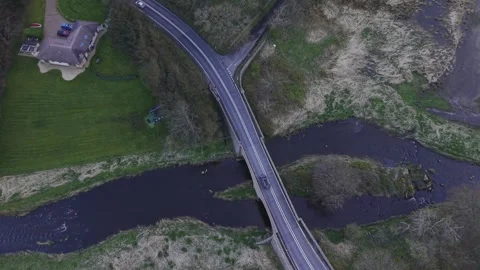 Aerial Top Down View of Bridge Over River with Curving Road Video stock 333784345