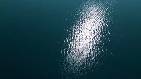Aerial Top Down View of Bright Sun Reflection on Deep Blue Sea Water Stock Footage 340619204