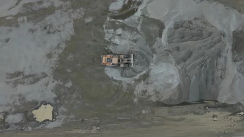 Aerial top-down view of bulldozer moving sand at a construction site Stock Footage 343844245