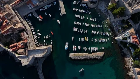 Aerial top-down view of a busy harbor filled with yachts and boats Stock Footage 345118177