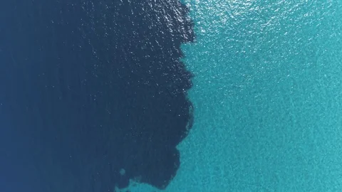 Aerial top down view. Calm clear blue sea water background. 4K Video stock 116983659