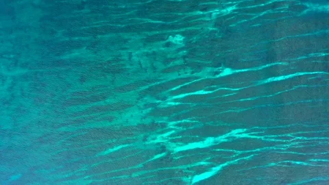 Aerial top down view of calm sea water background. Perfectly crystal clear blue Stock Footage 129279986