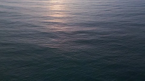 Aerial Top Down View of Calm Sea Water Surface at Sunset Видео 331305131