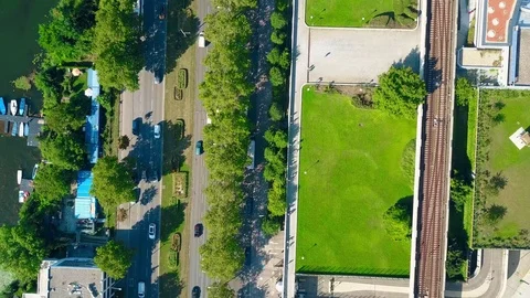 Aerial top down view of car road, boat berth and railroad on a sunny summer day Stock Footage