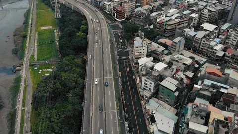 Aerial top down view of a car bridge, between the buildings and trees Video stock 103563949