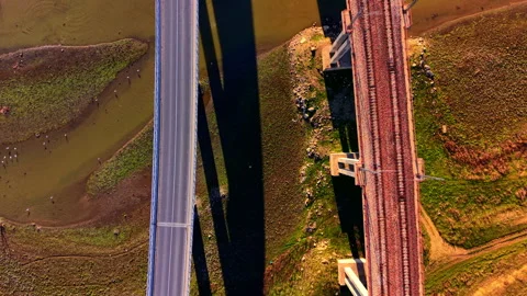 Aerial top down view of car on road bridge and railway bridge Stock Footage 333839121