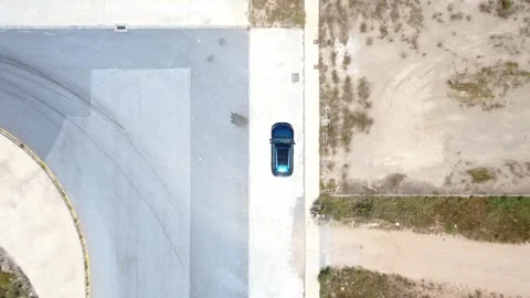 Aerial top down view of a car reversing in a parking lot Stock Footage 336074519