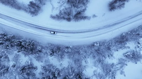 Aerial top down view of car driving on a snowy road, Norway 스톡 동영상 340238883