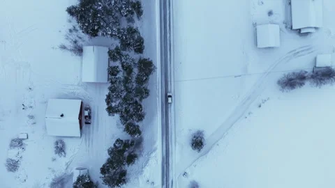 Aerial top down view of car driving on winter snow covered road, Norway Stock Footage 340238942