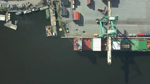 Aerial top down view cargo ship moored at container terminal port Stock Footage 130648693