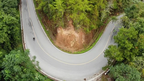 Aerial: Top Down View Of Cars/scooters On A Curvy Road in the mountains Stock Footage 100575628
