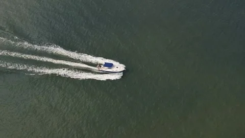 Aerial Top Down View Of Catching Luxury Motor Boat Racing On The Water Stock Footage 246822960
