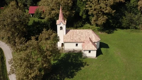 Aerial top-down view of a charming rural church surrounded by lush greenery. Stock Footage 285773401