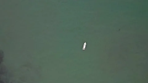 Aerial top down view, circling around a small boat Stock Footage 146344400