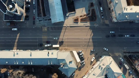 Aerial top down view of city road with car traffic among urban buildings and Stock Footage 106098558