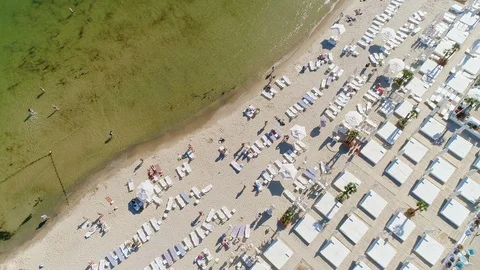 Aerial top down view on a city beach. Crowd of people resting and swimming on Stock Footage 107499199
