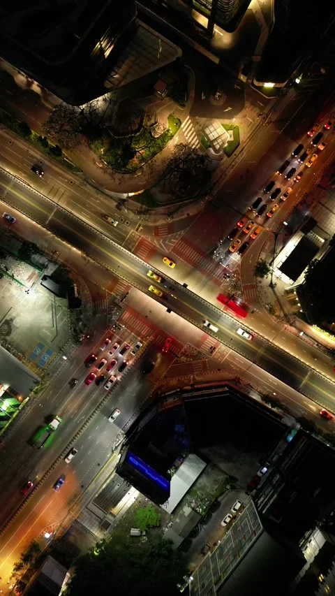Aerial Top Down View of City Traffic Intersection at Night in Bangkok, Thailand Stock Footage 333597929