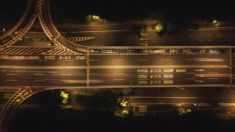 Aerial top down view of a city highway interchange at night with moving cars and Stock Footage 340901804