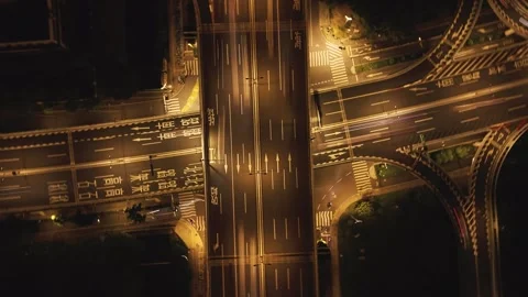 Aerial top down view of a city highway interchange at night with moving cars and Stock Footage 340901818