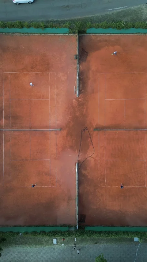 Aerial Top-Down View of Clay Tennis Courts with Players During Match Stock-Footage 343431695