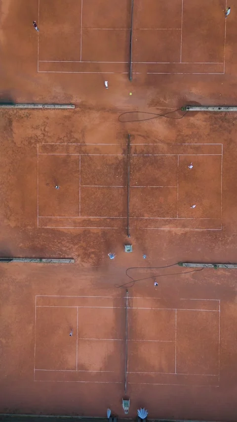 Aerial Top-Down View of Clay Tennis Courts with Players During Match Stock-Footage 343432316