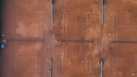 Aerial Top-Down View of Clay Tennis Courts with Players During Match Stock-Footage 343432374