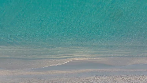 Aerial top-down view of clear sea waters and beach Stock Footage 263680526