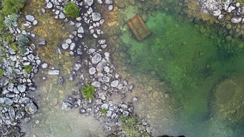 Aerial Top-Down View of a Clear Alpine River with a Mysterious Sunken Crate Stock Footage 341827612