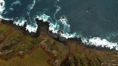 Aerial top down view from a cliff top over waves crashing in North Iceland Stock Footage 116549255