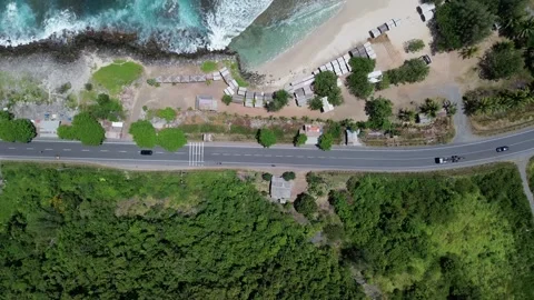 Aerial top down view of a coastal highway running along a tropical beach 库存影片 342577042