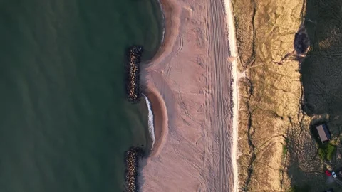 Aerial Top-Down View of Coastal Village, Beach and Breakwaters Stock Footage 343515938