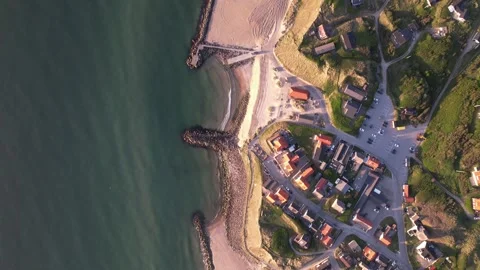 Aerial Top-Down View of Coastal Village, Beach and Breakwaters Stock Footage 343516173