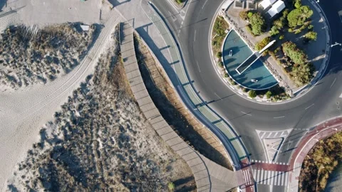 Aerial top down view of coastal roundabout and sports courts Stock Footage 344529684