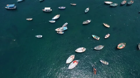 Aerial Top Down View of Colorful Fishing Boats in Turquoise Harbor Stock Footage 344163340